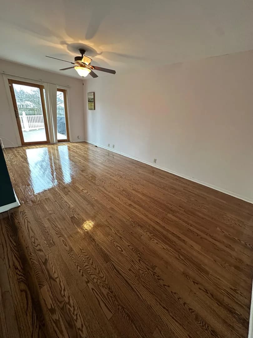 Dark-stained oak floor under a ceiling fan