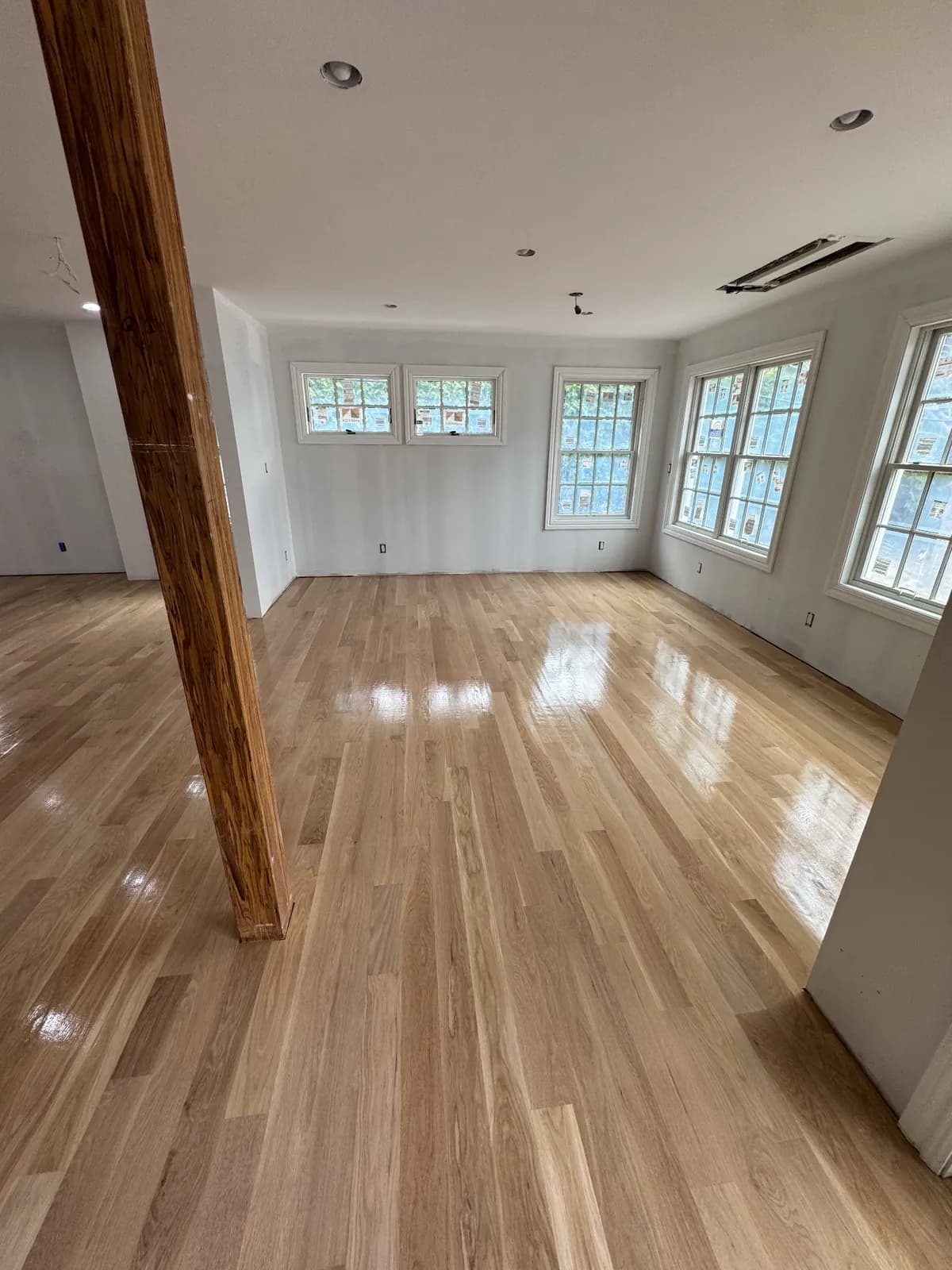Pale oak floor in a room lined with windows on two sides